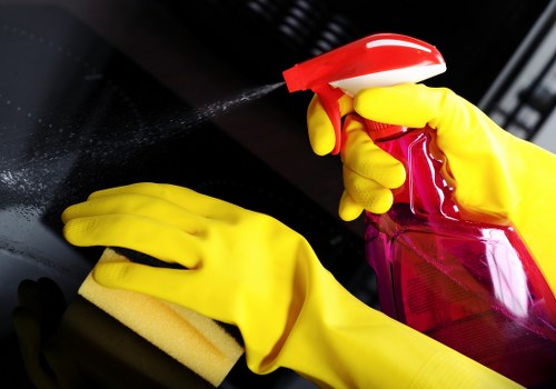 Office cleaning team handling desks and shared surfaces in Belsizepark