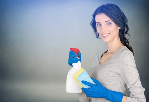 Cleaner preparing kitchen surfaces during a Belsizepark home cleaning visit